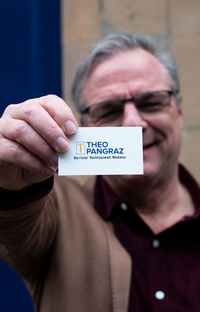 Theo Pangraz holding his business card up to the camera