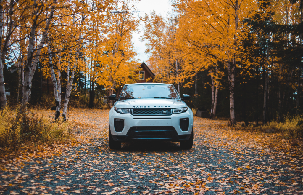 Your consumer rights when things go wrong with a car purchase. White Range Rover on road with autumn trees in background
